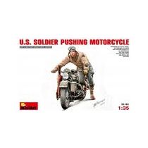 U.S.SOLDIER PUSHING MOTORCYCLE